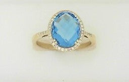Ladies 14 Karat Yellow Gold Fashion Ring With = 0.11Tw Round G/H SI2 Diamonds And = 3.50Tw Oval Blue Topaz Size 6.5