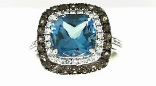 Ladies 14 Karat White Gold Fashion Ring With = 2.50Tw Cushion Blue Topaz = 0.18Tw Round H/I Si2 Brown Diamonds And 0.10 Twt H/I Si2 Diamonds Size 7.5